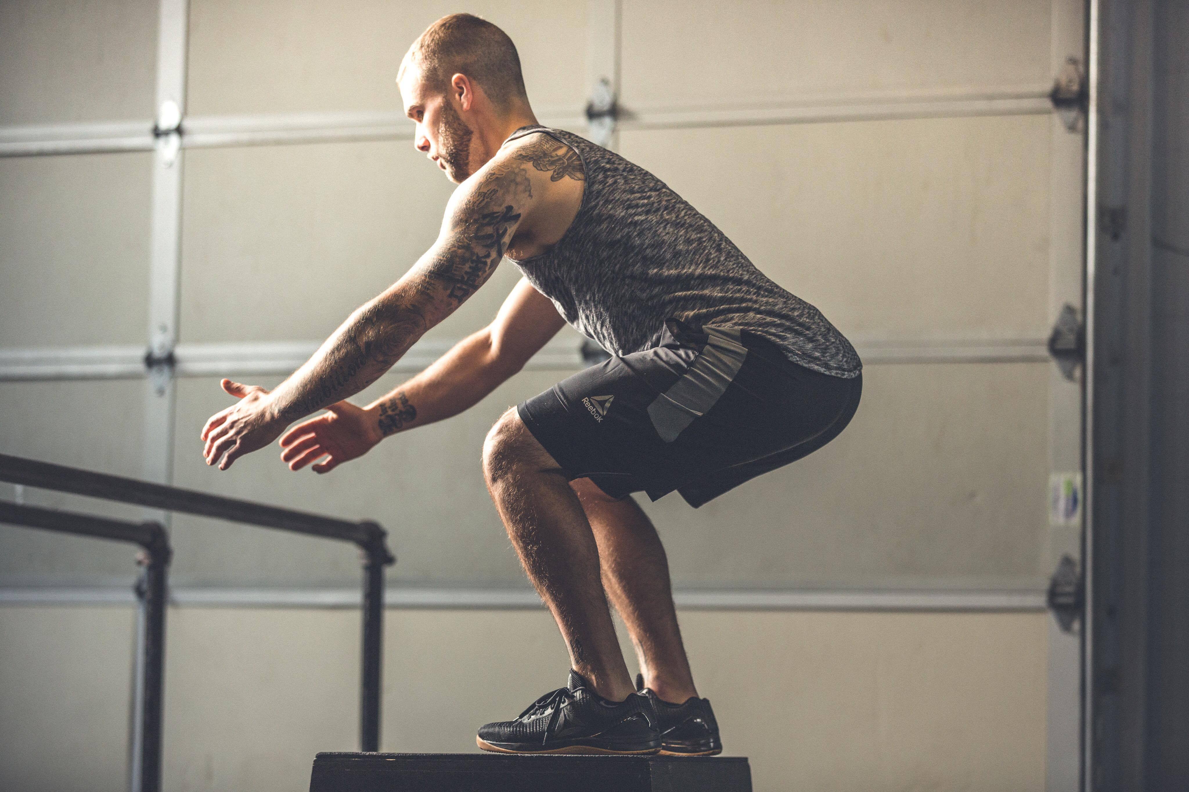 This image shows Cody jumping on a plyo box, to imply training intensity.