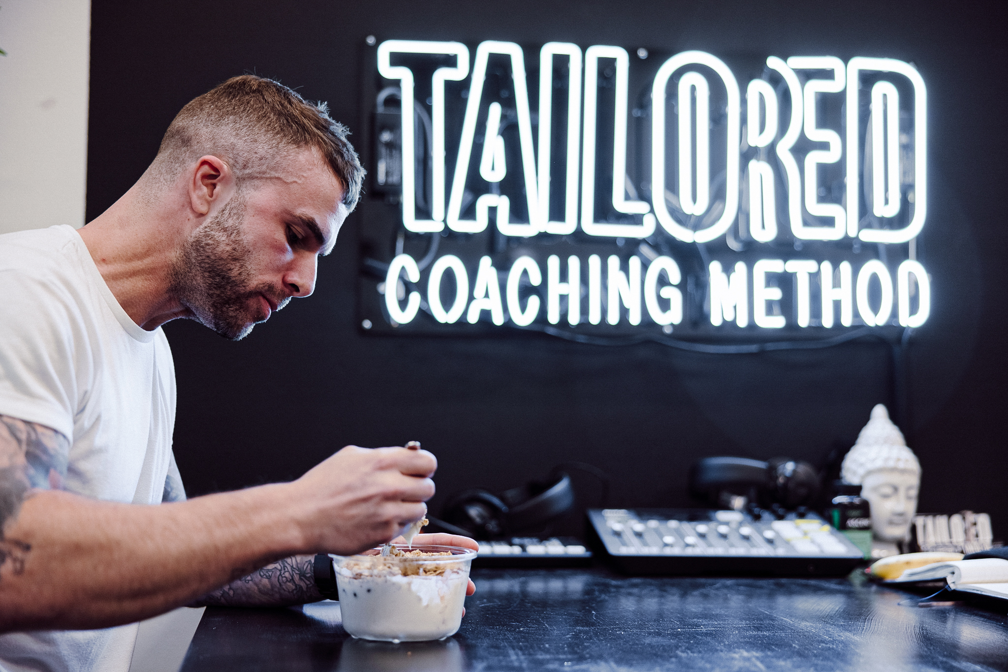 Coach Cody eating a prepped meal at Tailored HQ