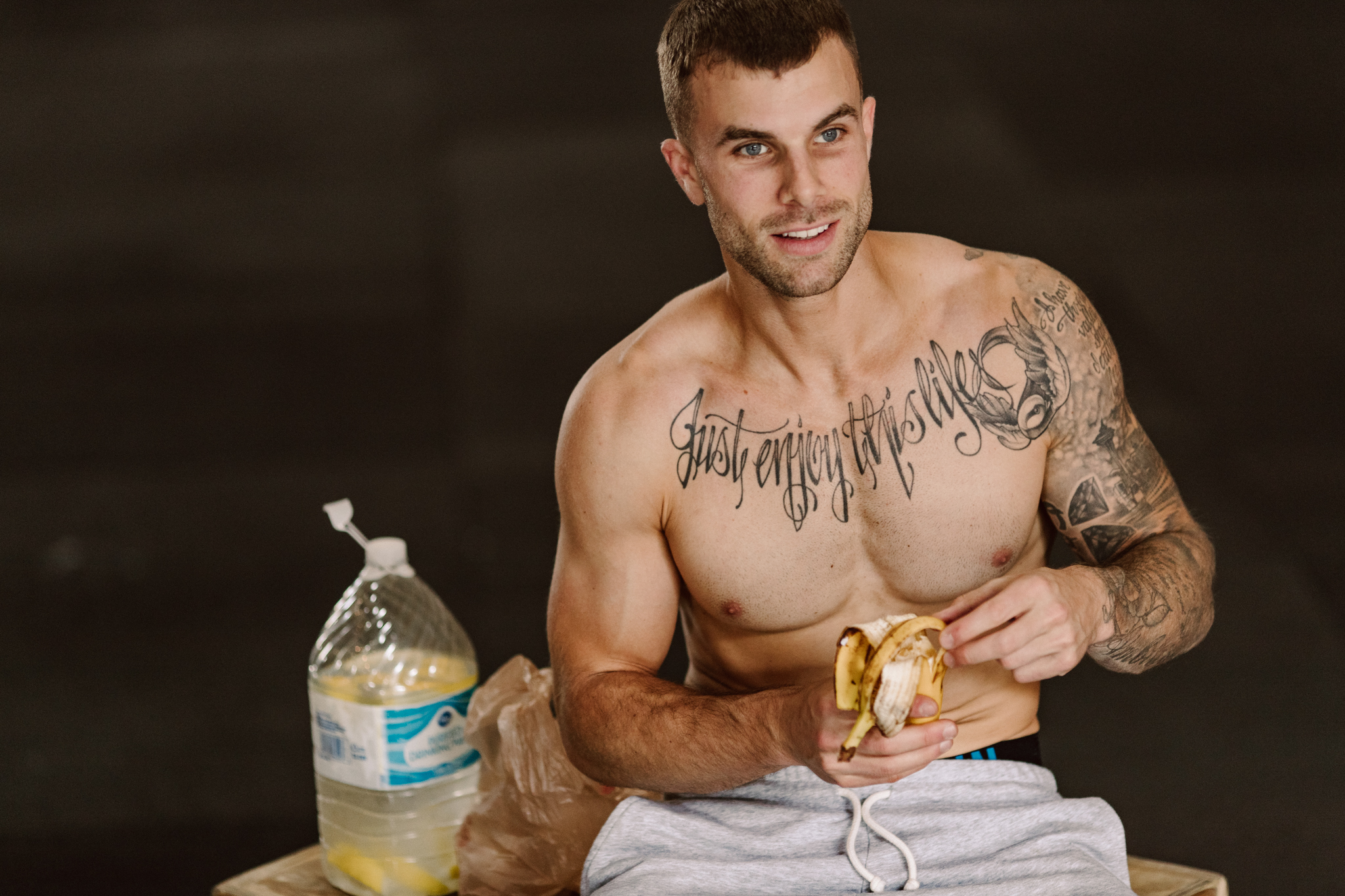 Coach Cody eating a banana, smiling.