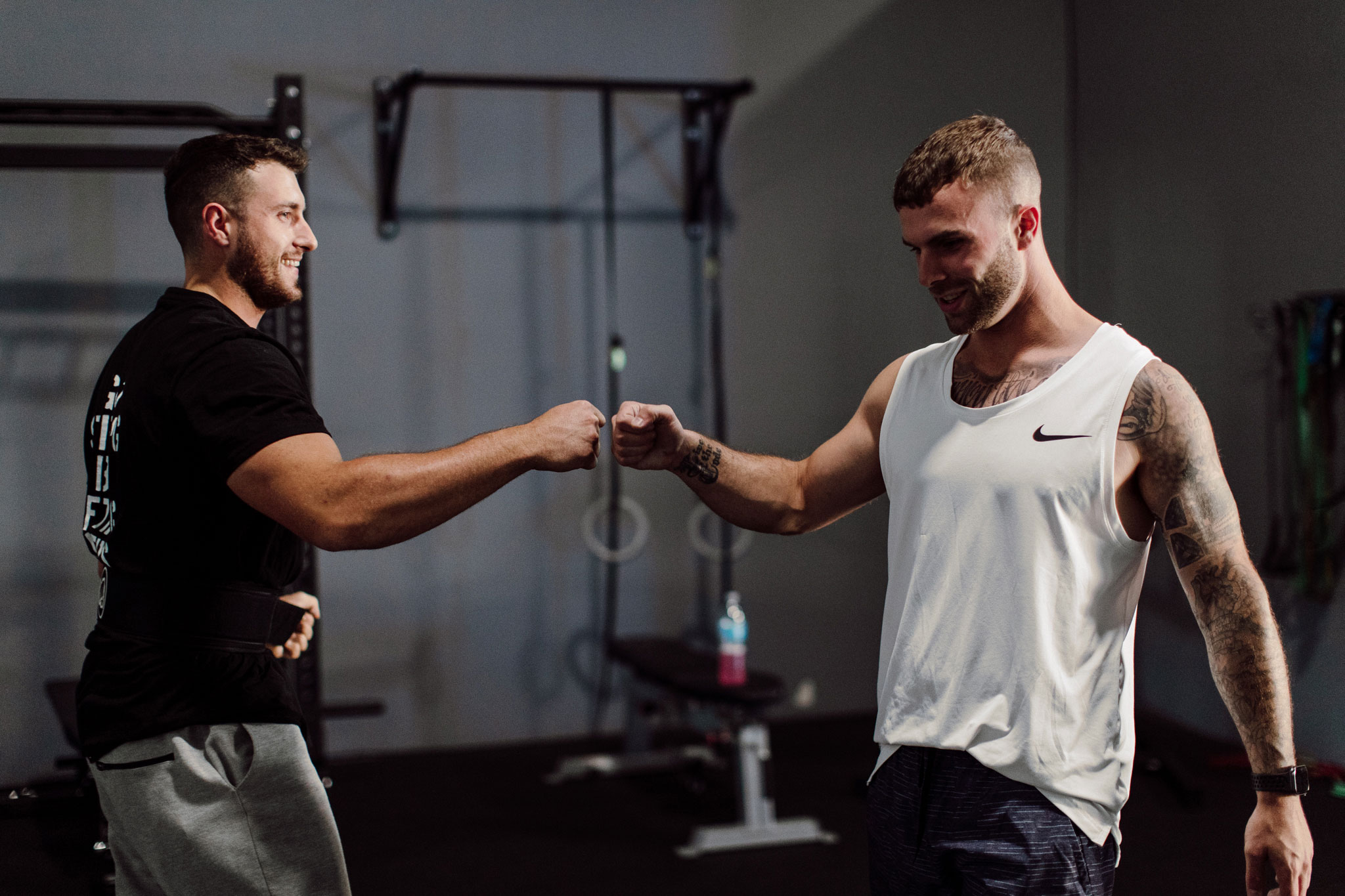 Gym partners fist bumping