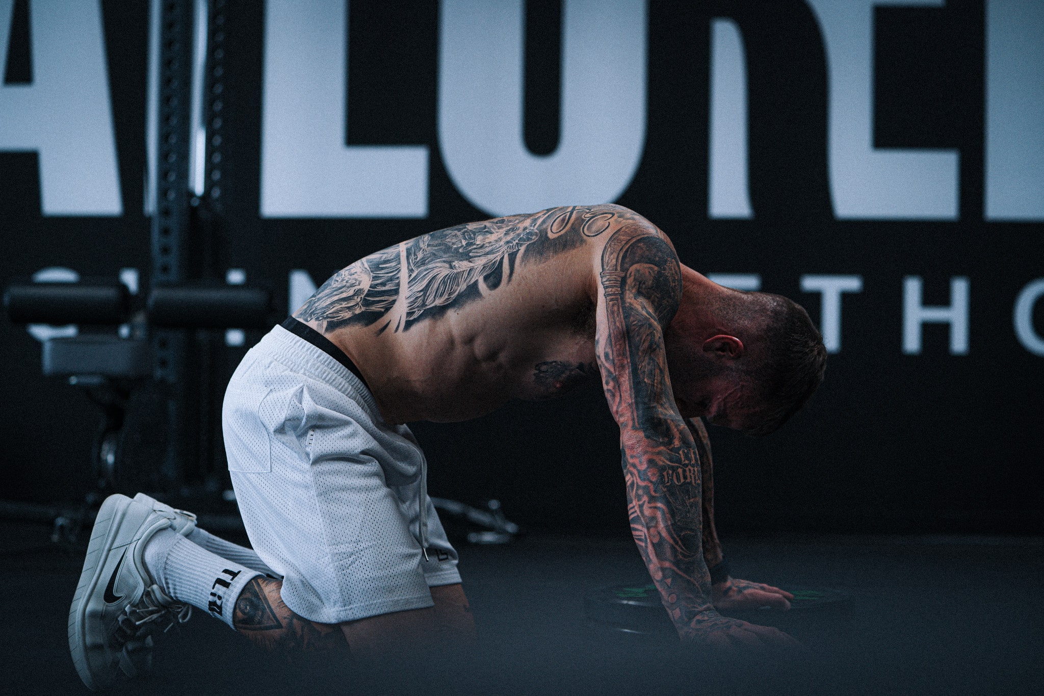 Cody McBroom on the floor panting and breathing hard after a difficult workout.