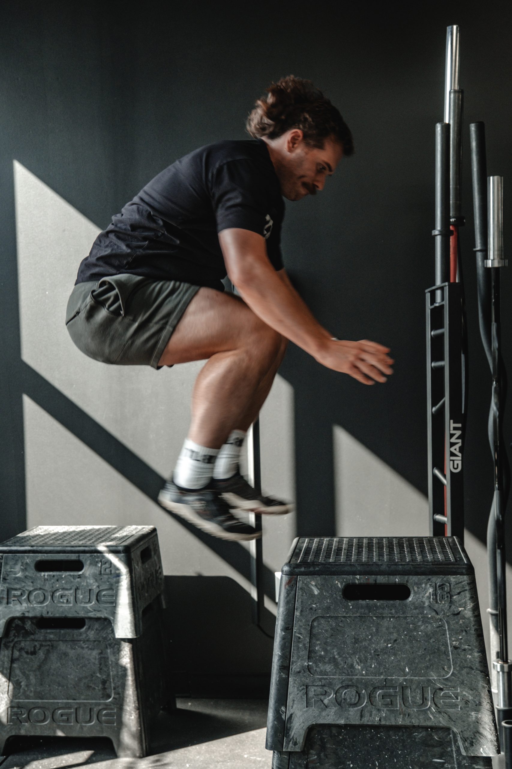 Kyle Johnson doing box jumps at the tailored coaching method headquarters
