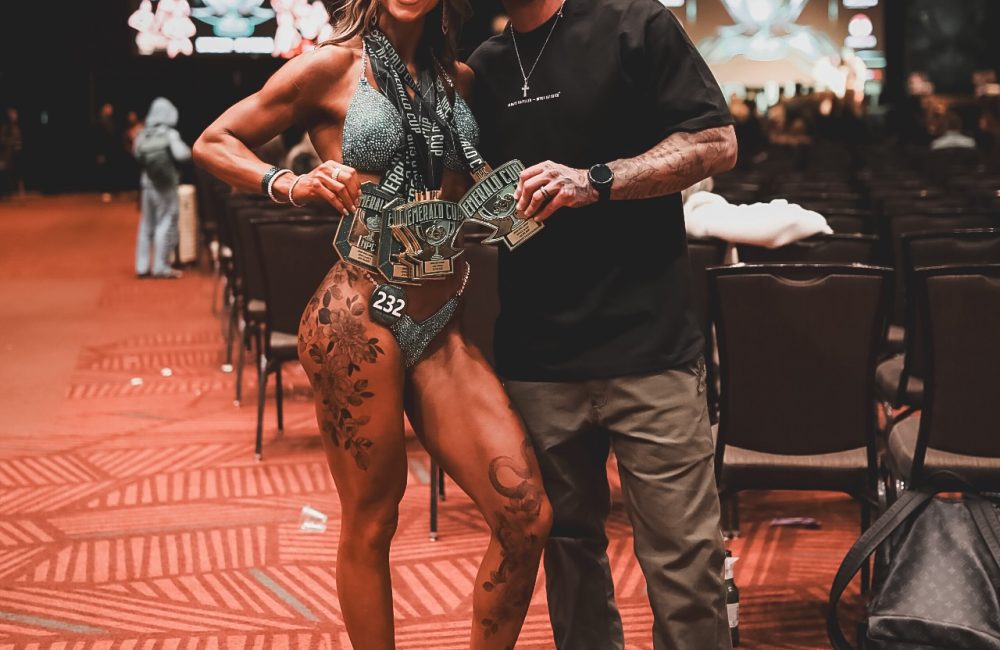 Coach Cody McBroom, founder of Tailored Coaching Method, with his client Kimi Girmus at Emerald Cup 2026, where she won 6 medals across Bikini and Wellness Physique Competition Categories.