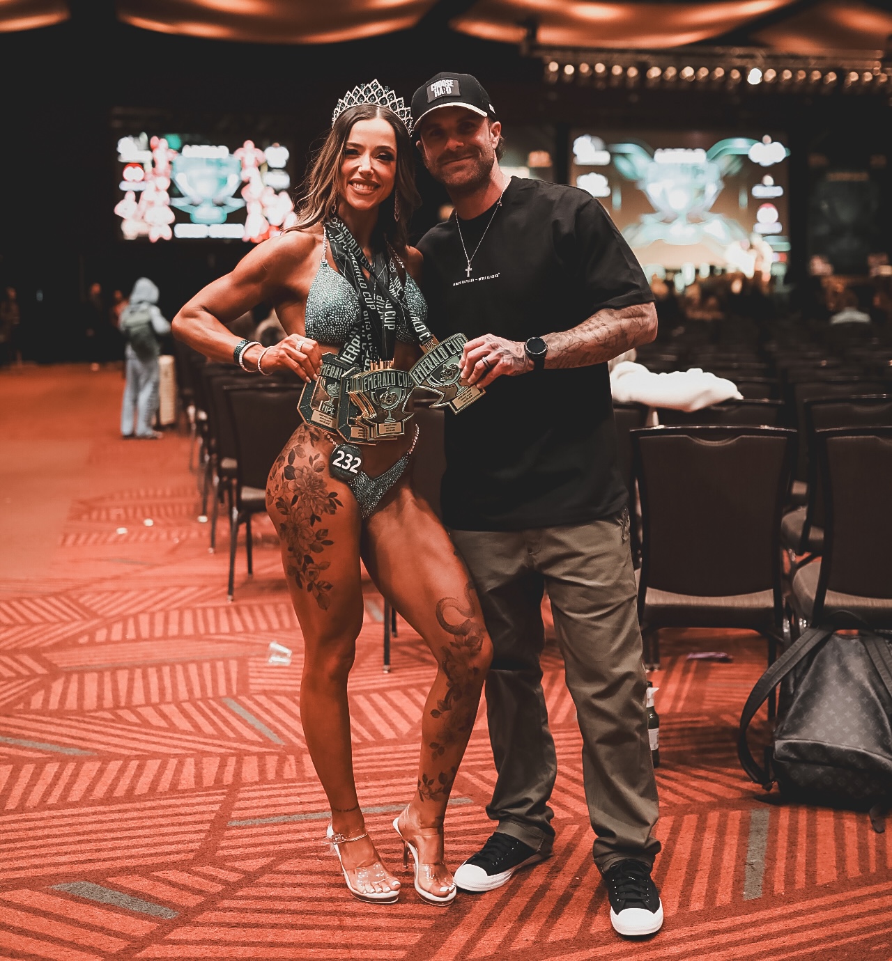 Coach Cody McBroom, founder of Tailored Coaching Method, with his client Kimi Girmus at Emerald Cup 2026, where she won 6 medals across Bikini and Wellness Physique Competition Categories.
