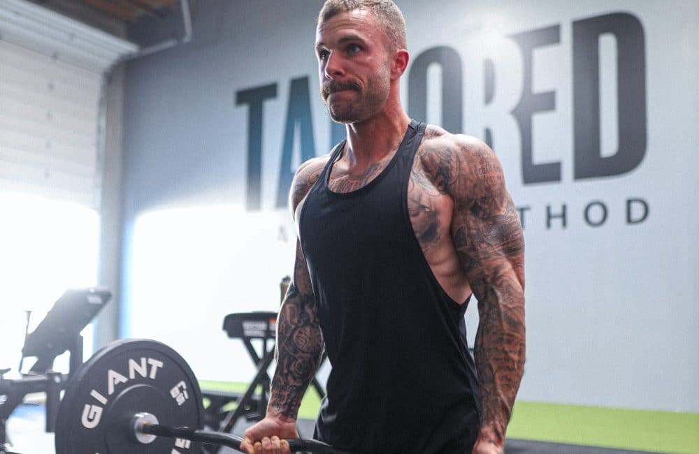 Lifter performing a heavy resistance training set to build muscle hypertrophy