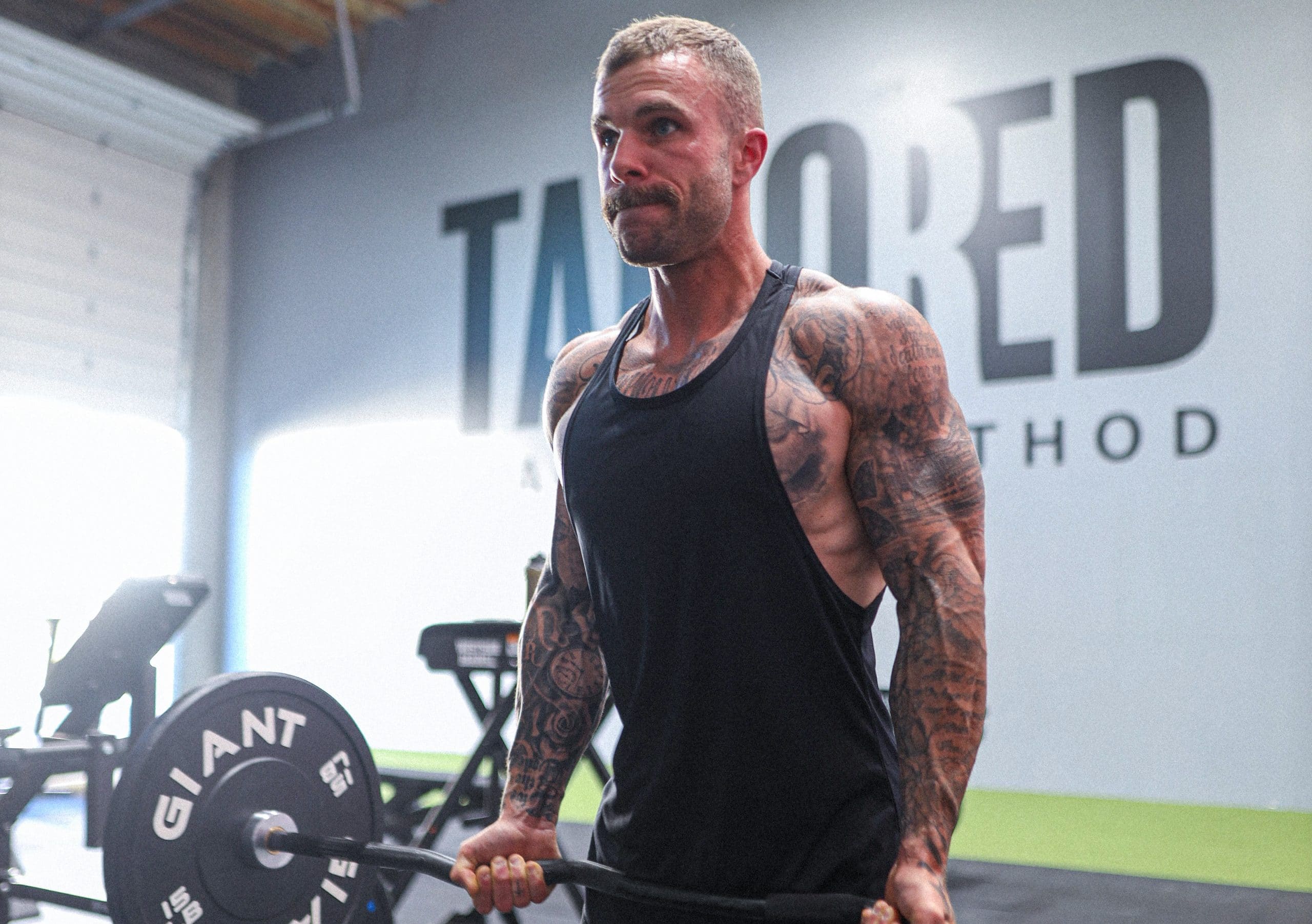 Lifter performing a heavy resistance training set to build muscle hypertrophy