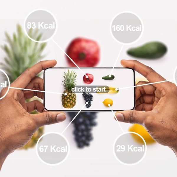 Woman holding cellphone with application which counting calories by photo, background, panorama