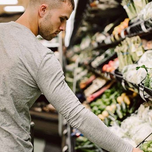 A man selecting vegetables at the supermarket